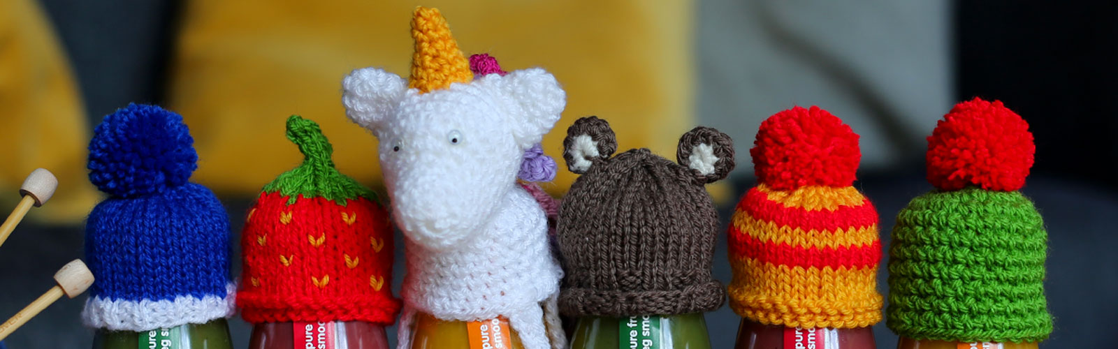 A line of innocent smoothies wearing little woolly hats