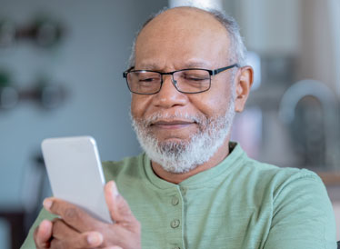 Man smiling using smartphone to download an app